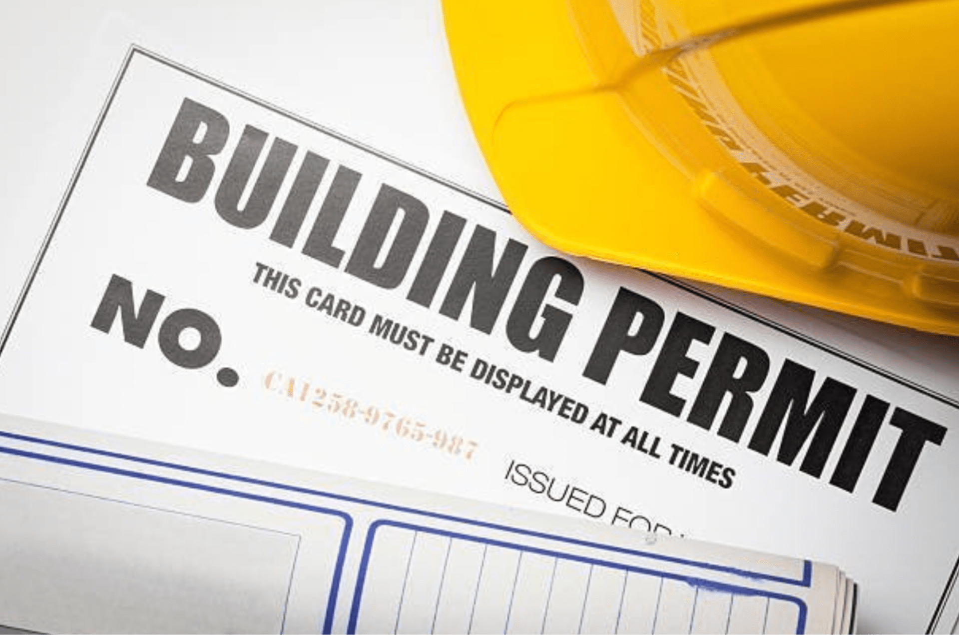 Construction building permit on desk with hard hat Construction building permit on desk with hard hat.